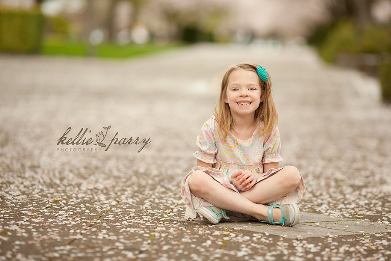 girl sitting in cherry blossoms