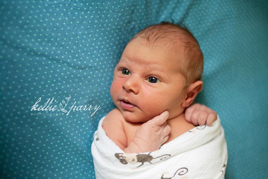 swaddled in his crib