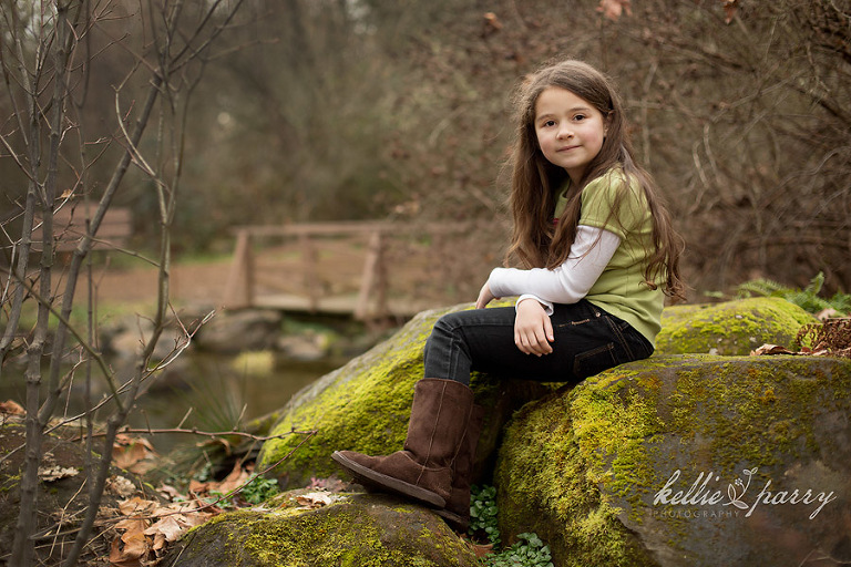 girl on some mossy rocks