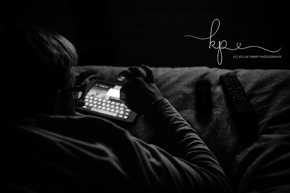 man on iPad watching tv