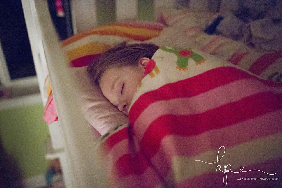 girl sleeping in her bunk bed