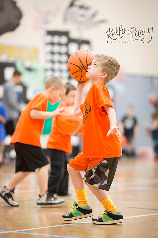 boy playing basketball in gym