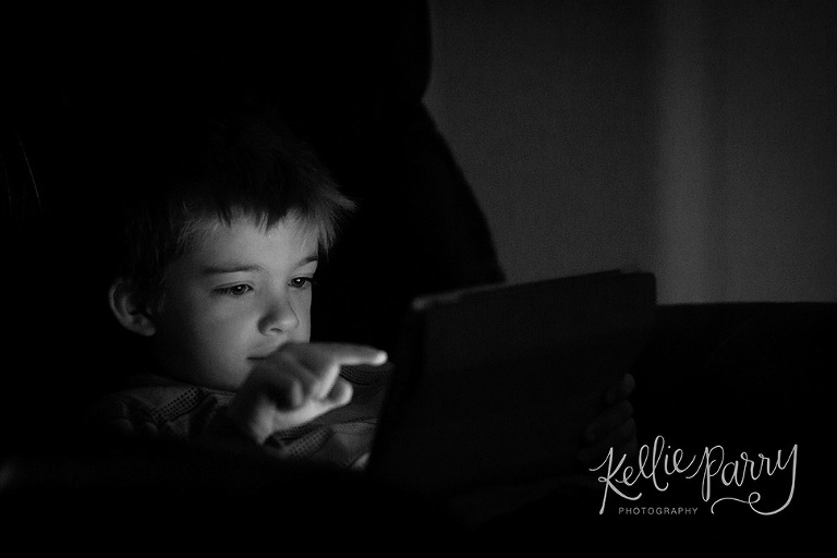 boy playing with iPad in the dark
